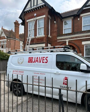Javes Security van outside house with ladder.